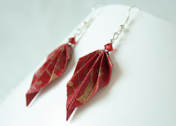 Boucles d'oreille en origami surmontées de perles rouges.