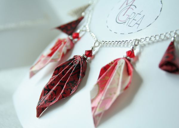 Collier en origami avec feuilles rouges et grappes.